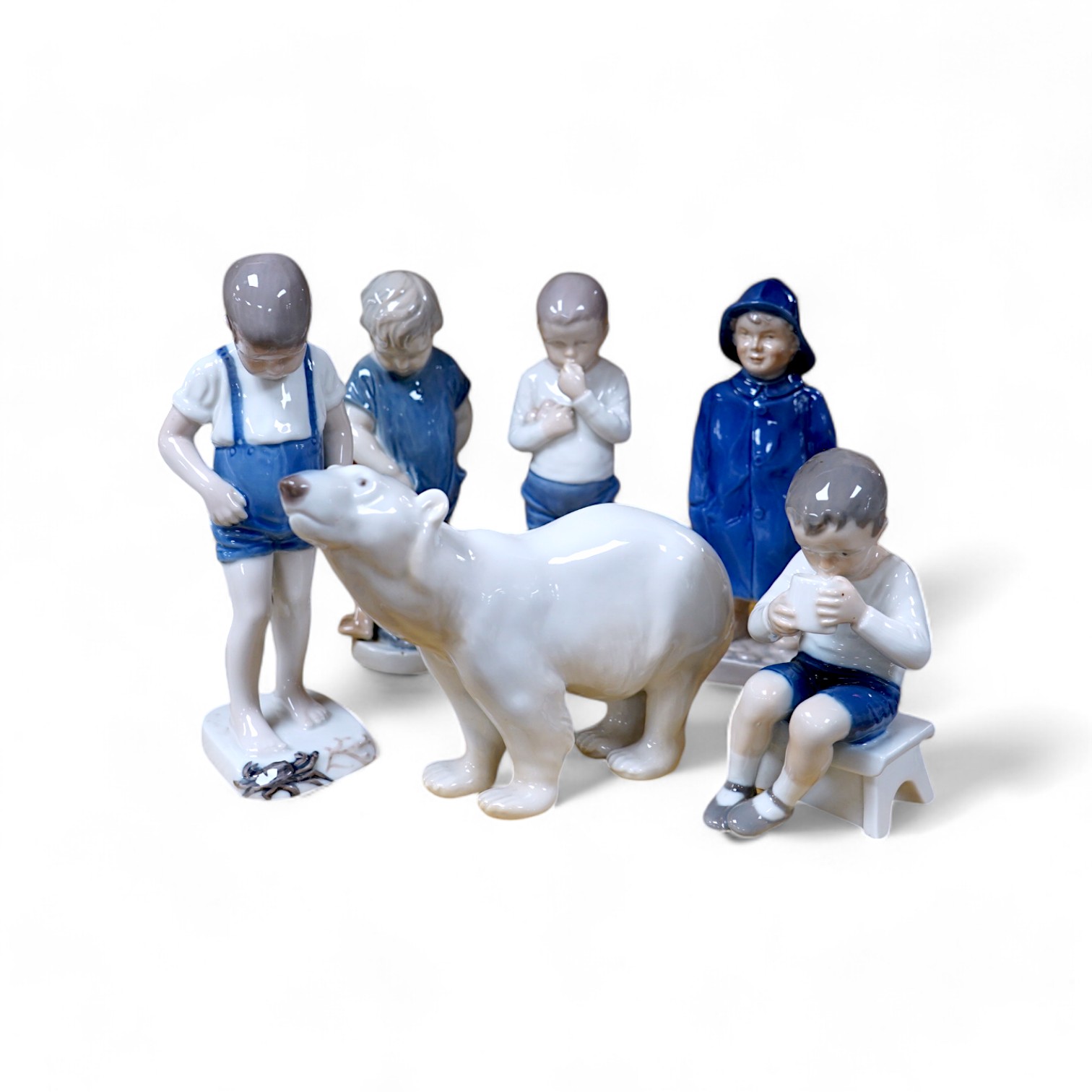 Six Royal Copenhagen or B & G figures of children and a polar bear, tallest 19.5cm. Condition - good.